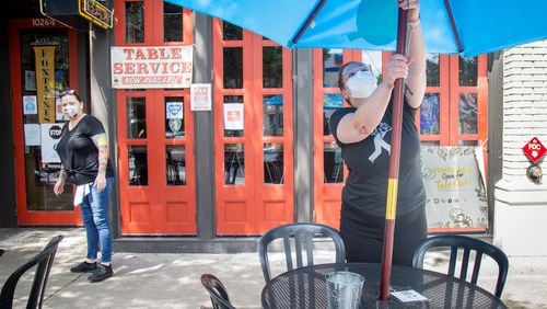 Alex Hall (R) sets up tables in preparation for lunch in front of Fontaine's Oyster House Saturday 1, 2020.  STEVE SCHAEFER FOR THE ATLANTA JOURNAL-CONSTITUTION