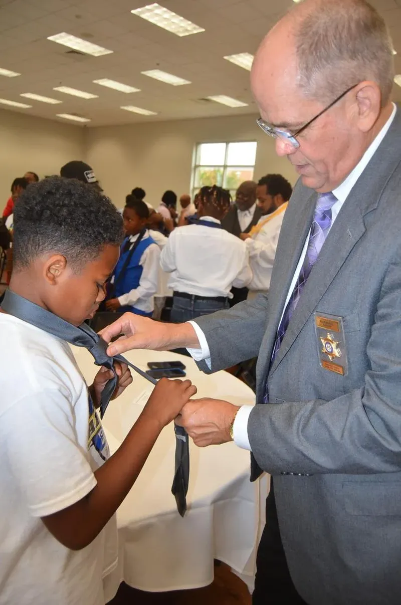 The annual luncheon, hosted by the Phoebe Network of Trust, gives the kids the opportunity to learn to tie a necktie and spend time with the adults males in their community. (Photo Courtesy of Alan Mauldin)