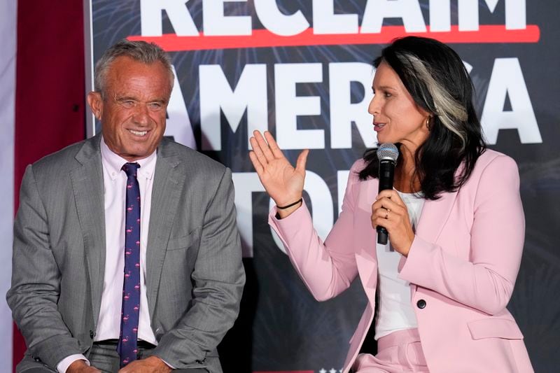 Former Independent candidate for president Robert F. Kennedy, Jr., left, and former Democratic Rep. Tulsi Gabbard speak at a campaign event for Republican presidential nominee former President Donald Trump, Saturday, Sept. 14, 2024, in Glendale, Ariz. (AP Photo/Ross D. Franklin)