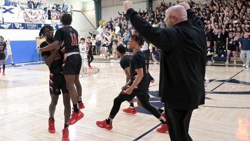 The Jonesboro Cardinals react after winning their class 5A second round tournament Saturday, Feb. 26, 2022 at St. Pius X Catholic School in Atlanta. Jonesboro won with a final score of 65-64. (Daniel Varnado/For the Atlanta Journal-Constitution)