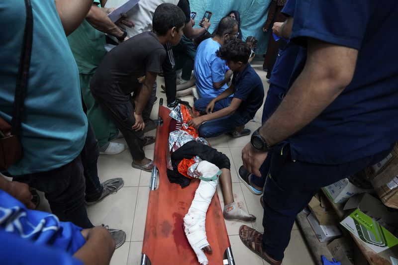 Palestinian medics treat people wounded in an Israeli bombardment on the Gaza Strip at Al Aqsa hospital in Deir al Balah, central Gaza Strip, on Sunday, May 26, 2024. (AP Photo/Abdel Kareem Hana)