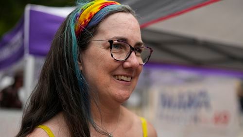 Illinois Rep. Kelly Cassidy talks with visitors to the Glenwood Avenue Arts Festival about canvassing efforts for the Democratic Party, Monday, Aug. 26, 2024, in Chicago. (AP Photo/Erin Hooley)