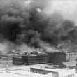 FILE - In this 1921 image provided by the Library of Congress, smoke billows over Tulsa, Okla. (Alvin C. Krupnick Co./Library of Congress via AP, File)