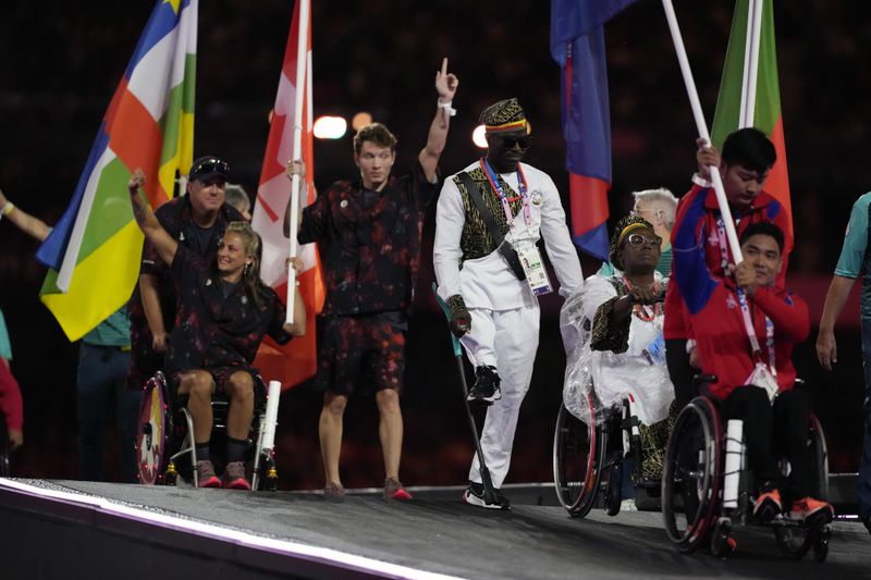 Athletes from different delegations parade during the closing ceremony of the 2024 Paralympics, Sunday, Sept. 8, 2024, in Paris, France. (AP Photo/Michel Euler)