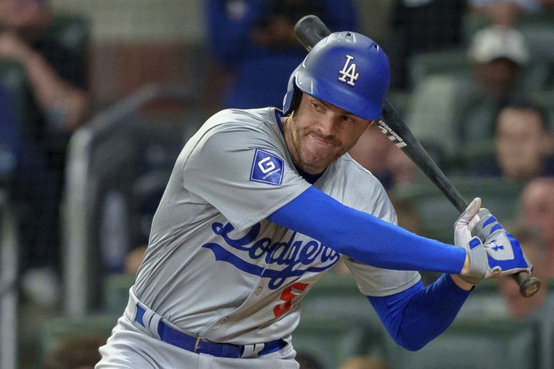 Los Angeles Dodgers' Freddie Freeman swings in the fourth inning of a baseball game against the Atlanta Braves, Monday, Sept. 16, 2024, in Atlanta. (AP Photo/Jason Allen)