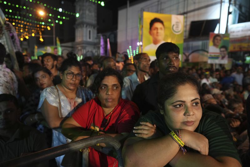 Women listen to Sajith Premadasa, unseen, the presidential candidate and opposition leader of the Samagi Jana Balawgaya or United People's Power party during an election rally, in Colombo, Sri Lanka, Wednesday, Sept. 18, 2024. (AP Photo/Rajesh Kumar Singh)