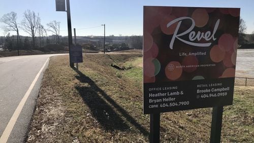 A sign advertising the Revel development outside a construction site near Gwinnett’s Infinite Energy Campus. Revel’s developer, North American Properties, announced Tuesday it was pulling out of the project. TYLER ESTEP / TYLER.ESTEP@AJC.COM