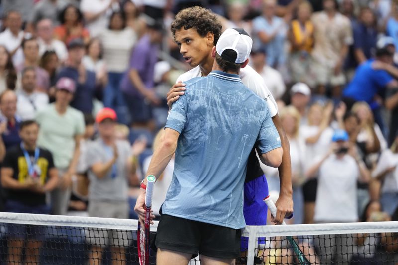 Gabriel Diallo, of Canada,, left, greets Tommy Paul, of the United States, at the net after Paul won their third round match of the U.S. Open tennis championships, Saturday, Aug. 31, 2024, in New York. (AP Photo/Kirsty Wigglesworth)