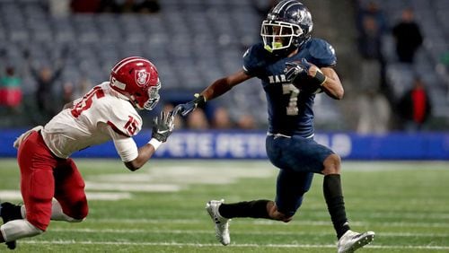 Marietta wide receiver Ricky White (7) makes a move on Lowndes defensive back Tylar Belcher (15) in the first half of the Class AAAAAAA high school football state title game at Georgia State Stadium Saturday, December 14, 2019 in Atlanta. (JASON GETZ/SPECIAL TO THE AJC)