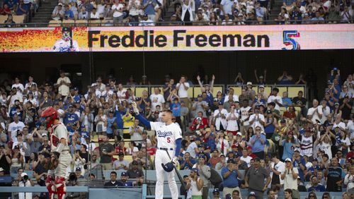 Los Angeles Dodgers' Freddie Freeman waves to the stands during the first inning of a baseball game against the Philadelphia Phillies in Los Angeles, Monday, Aug. 5, 2024. Freeman has missed last eight games as his youngest son Maximus was diagnosed with Guillan-Barre syndrome. (AP Photo/Kyusung Gong)