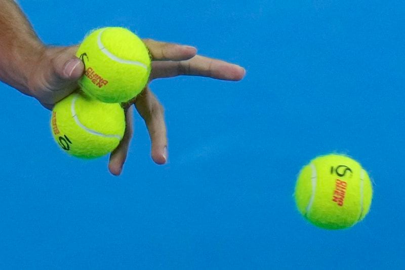 Carlos Alcaraz of Spain chooses balls during the men's singles finals match against Jannik Sinner of Italy at the China Open tennis tournament, National Tennis Center in Beijing, Wednesday, Oct. 2, 2024. (AP Photo/Andy Wong)