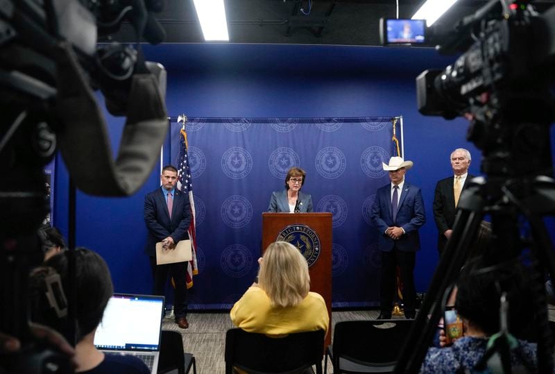 Harris County District Attorney Kim Ogg announces corruption charges related to 2022 Election alongside Michael Levine, Chief Assistant District Attorney for Public Corruption, left, First Assistant/Chief of Courts David Mitcham, right, and Ryan Christian, with the Texas Rangers, second right, during a press conference Tuesday, Aug. 13, 2024, in Houston. Ogg said that her office will pursue criminal charges against a county employee who was allegedly working a second job while polls ran out of paper ballots. (Raquel Natalicchio/Houston Chronicle via AP)