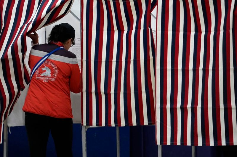 A voter enters a booth to fill out a ballot in a primary election to pick candidates for governor, the U.S. House, and the state Legislature, Tuesday, Sept. 10, 2024, in Nashua, N.H. (AP Photo/Steven Senne)