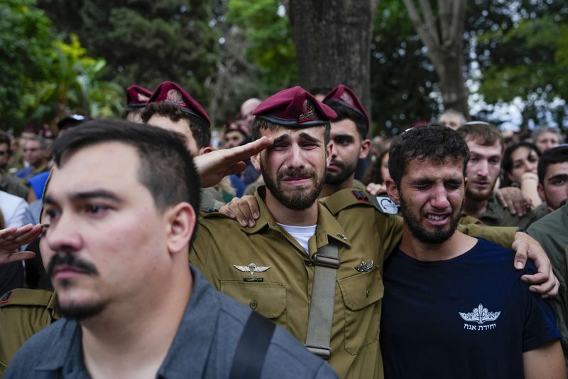 Mourners attend the funeral of Sgt. First Class Nazar Itkin who was killed during Israel's ground operation against Hezbollah militants in Lebanon, in Kiryat Ata, Israel, Sunday, Oct. 6, 2024. (AP Photo/Baz Ratner)