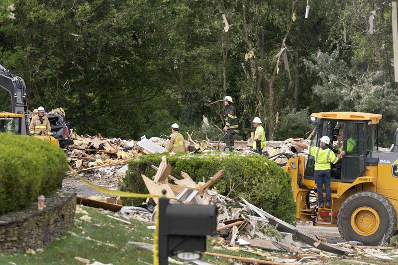 Crew workers remove the debris after a house exploded in the Bel Air, Md. neighborhood on Sunday, Aug. 11, 2024. (AP Photo/Jose Luis Magana)