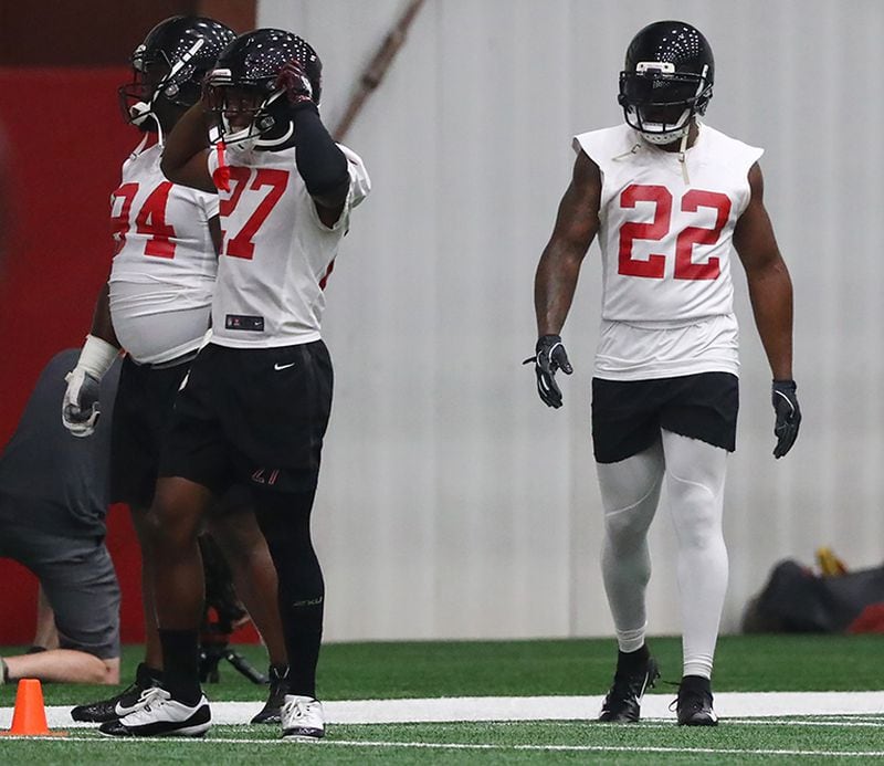 Falcons safety Keanu Neal (right) takes the field for drills during team practice on Thursday, June 6, 2019, in Flowery Branch.