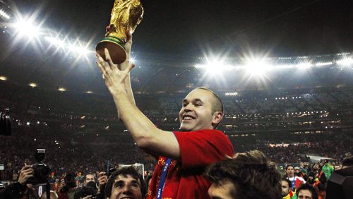 FILE - Spain's Andres Iniesta holds up the World Cup trophy after the World Cup final soccer match between the Netherlands and Spain at Soccer City in Johannesburg, South Africa, July 11, 2010. Andres Iniesta who scored Spain's World Cup-winning goal in 2010 and was one of the key players who made Barcelona's tiki-taka thrive for so long, announced his retirement from soccer on Tuesday. (AP Photo/Bernat Armangue, File)