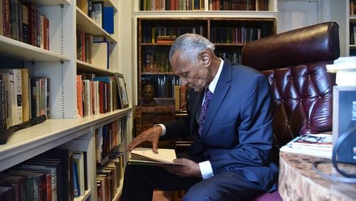 July 25, 2017 Atlanta - C.T. Vivian looks through a book at his home library on Tuesday, July 25, 2017. The National Monuments Foundation will be acquiring and managing the world-class library of Atlanta Civil Rights icon, C.T. Vivian. The library will be housed in the new Cook Park in Vine City. Vivian lived in the same Vine City neighborhood that will border Cook Park where his library is to be constructed under a 101-foot Peace Column. The 6,000 volume C.T. Vivian Library is one of the most impressive private collections in the city. HYOSUB SHIN / HSHIN@AJC.COM