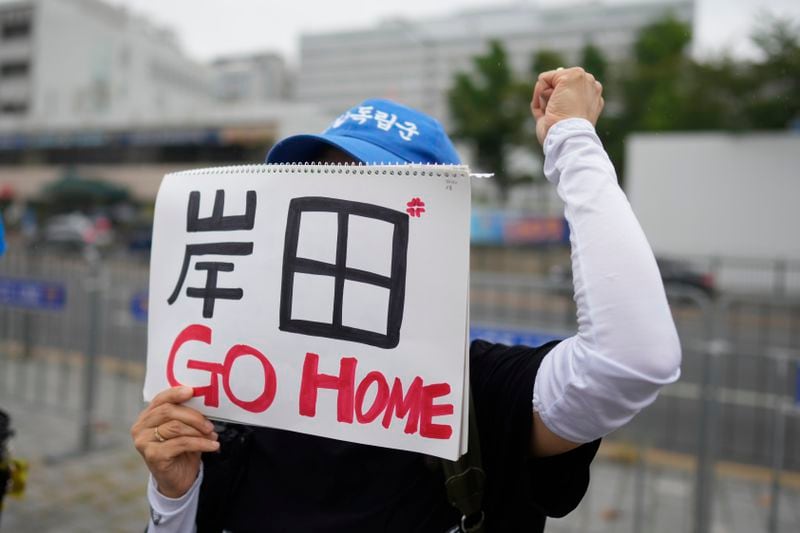 A protester shouts slogan with a sign reading "Kishida, Go Home" during a rally opposing a planned meeting between South Korean President Yoon Suk Yeol and Japanese Prime Minister Fumio Kishida near the Presidential Office in Seoul, South Korea, Friday, Sept. 6, 2024. (AP Photo/Lee Jin-man)