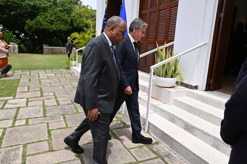 Haitian Prime Minister Garry Conille, front, and U.S. Secretary of State Antony Blinken enter the U.S. Chief of Mission Residence after speaking to the press in Port-au-Prince, Haiti, Thursday, Sept. 5, 2024. (Roberto Schmidt/Pool photo via AP)