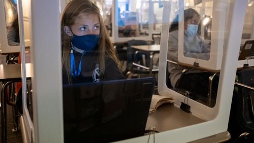 201105-Marietta-Celeste Martin works behind a plastic partition during her language arts class at Marietta Middle School on Thursday afternoon, Nov. 5, 2020. Even though there are only five students in the room during class, they all wear masks and sit behind plastic partitions. Ben Gray for the Atlanta Journal-Constitution