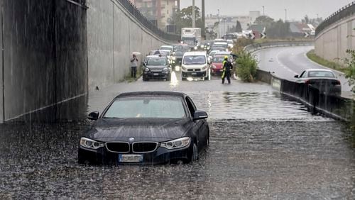 Cars are blocked in flooded streets in Milan, northern Italy, Thursday, Sept. 5, 2024. Lombardy and Veneto have been hit by widespread flooding, causing damage and disruption in the city of Milan, where the local Seveso and Lambro rivers overflowed. (Claudio Furlan/LaPresse via AP)