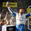 Driver Ricky Stenhouse Jr. celebrates in Victory Lane after a NASCAR Cup Series auto race at Talladega Superspeedway, Sunday, Oct. 6, 2024, in Talladega, Ala. (AP Photo/ Butch Dill)