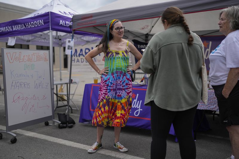 Illinois Rep. Kelly Cassidy talks with visitors to the Glenwood Avenue Arts Festival about canvassing efforts for the Democratic Party, Monday, Aug. 26, 2024, in Chicago. (AP Photo/Erin Hooley)