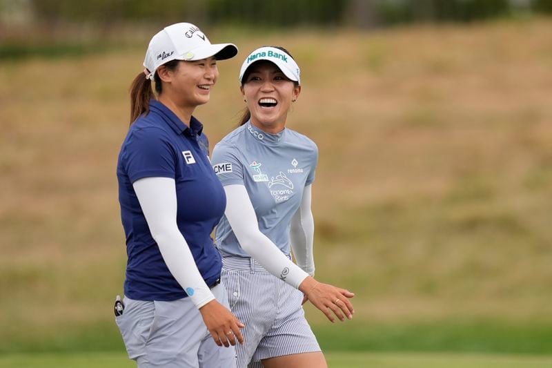 Lydia Ko, right, of New Zealand, and Yan Liu, left, of China, walk up the 17th fairway during the final round of the LPGA Kroger Queen City Championship golf tournament at TPC River's Bend in Maineville, Ohio, Sunday, Sept. 22, 2024. (AP Photo/Carolyn Kaster)