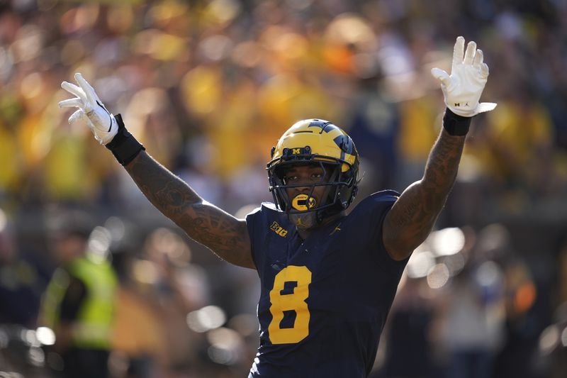 Michigan defensive end Derrick Moore (8) reacts to breaking up a pass against Southern California in the first half of an NCAA college football game in Ann Arbor, Mich., Saturday, Sept. 21, 2024. (AP Photo/Paul Sancya)