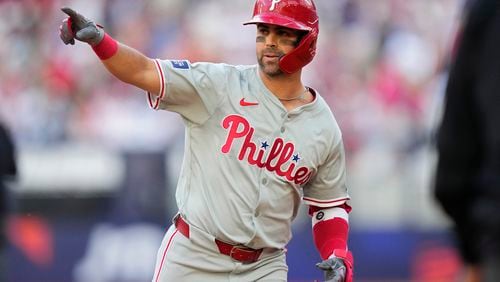 Philadelphia Phillies' Whit Merrifield celebrates after hitting a 3-run home run against the New York Mets during the fourth inning of a London Series baseball game in London, Saturday, June 8, 2024. (AP Photo/Kirsty Wigglesworth)