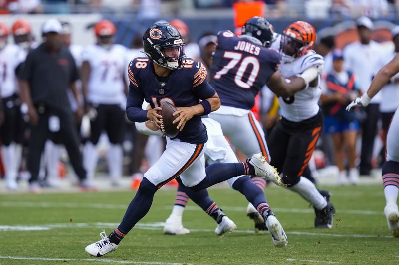 Chicago Bears quarterback Caleb Williams (18) scrambles out of the pocket during the first half of an NFL preseason football game against the Cincinnati Bengals, Saturday, Aug. 17, 2024, at Soldier Field in Chicago. (AP Photo/Charles Rex Arbogast)