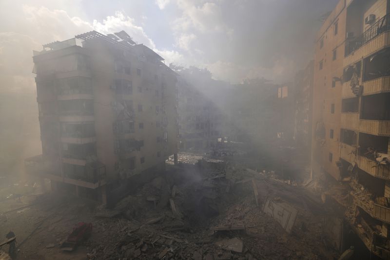 Smoke envelops the area near destroyed buildings at the site of an Israeli airstrike in Dahiyeh, Beirut, Lebanon, Wednesday, Oct. 2, 2024. (AP Photo/Hassan Ammar)