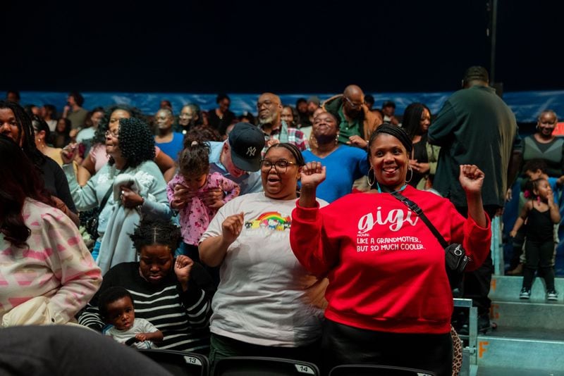 Members of the audience at UniverSoul Circus dance from their seats during a preview performance.