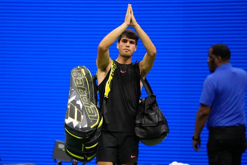 Carlos Alcaraz, of Spain, gestures to fans after losing to Botic van De Zandschulp, of the Netherlands, in a second round match of the U.S. Open tennis championships, Thursday, Aug. 29, 2024, in New York. (AP Photo/Frank Franklin II)