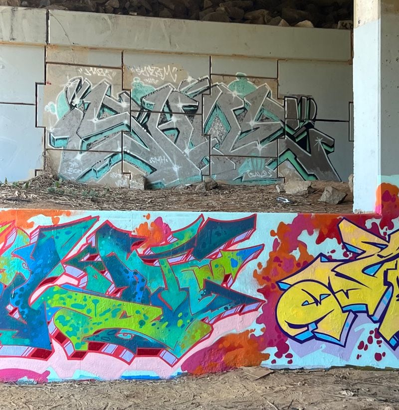 On an underpass under the iconic So So Def billboard on Interstate 75/85 south, an original installation from the artist Save in the 1990s (top) has been preserved while writers have created newer works on the wall below. Photo: Luke Gardner