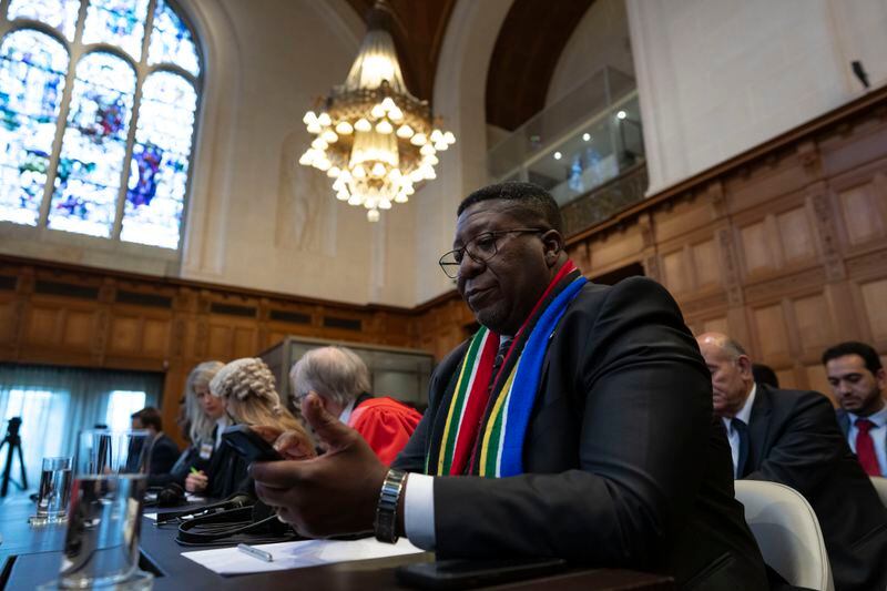 Ambassador of the Republic of South Africa to the Netherlands, Vusimuzi Madonsela, wait for judges to enter the International Court of Justice, or World Court, in The Hague, Netherlands, Friday, May 24, 2024, where the top United Nations court was to rule on an urgent plea by South Africa for judges to order Israel to halt its military operations in Gaza and withdraw from the enclave. (AP Photo/Peter Dejong)