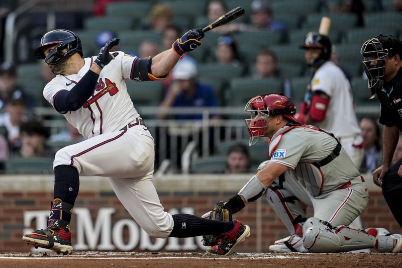 Atlanta Braves outfielder Adam Duvall (14) hits a single in the second inning in the of a baseball game against the Philadelphia Phillies, Thursday, Aug. 22, 2024, in Atlanta. (AP Photo/Mike Stewart)