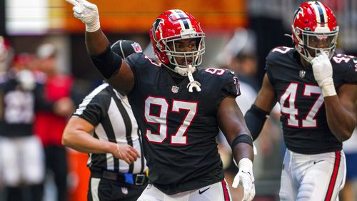 Atlanta Falcons defensive end Grady Jarrett (97) signals during the first half of an NFL football game against the San Francisco 49ers, Sunday, Oct. 16, 2022, in Atlanta. (AP Photo/Danny Karnik)