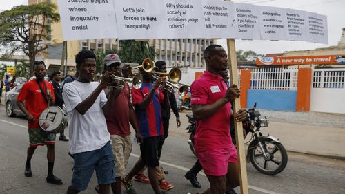 Texas Kadri Moro, the Executive Director of Arise for Justice International, protests with placards nailed on a cross on the street of Accra, Ghana, Thursday Sept 12, 2024. Texas Kadiri Moro is an unusual figure amid the LGBTQ+ rights activists in the coastal West African nation of Ghana. He is heterosexual, married to a woman and a father of six. He is a teacher. And he is a practising Muslim. (AP Photo/ Misper Apawu)