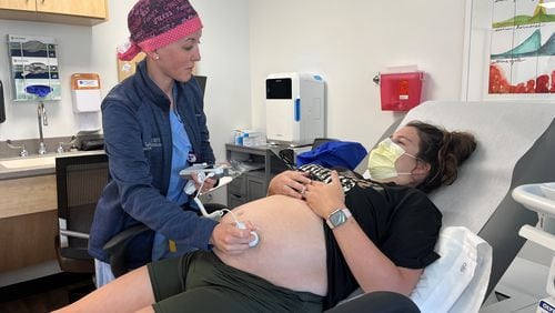 Obstetrician and gynecologist Taylar Swartz uses an ultrasound scanner to check the health of Addie Comegys’ baby on May 30, 2024. Comegys, who was seven months pregnant, had traveled 45 minutes for her prenatal appointment at Mahaska Health in Oskaloosa, one of a few rural hospitals in Iowa still offering labor and delivery services. (Tony Leys/KFF Health News/TNS)