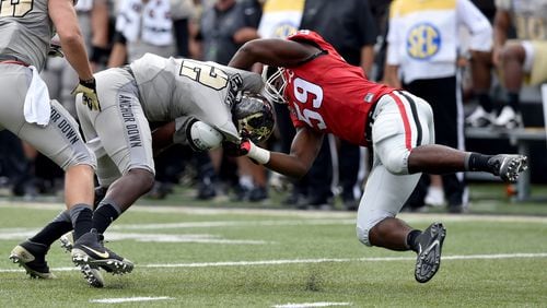 September 12, 2015 Nashville, TN : Georgia Bulldogs linebacker Jordan Jenkins brings down Vanderbilt Commodores quarterback Johnny McCrary during the first half in Nashville Saturday September 12, 2015. BRANT SANDERLIN /BSANDERLIN@AJC.COM