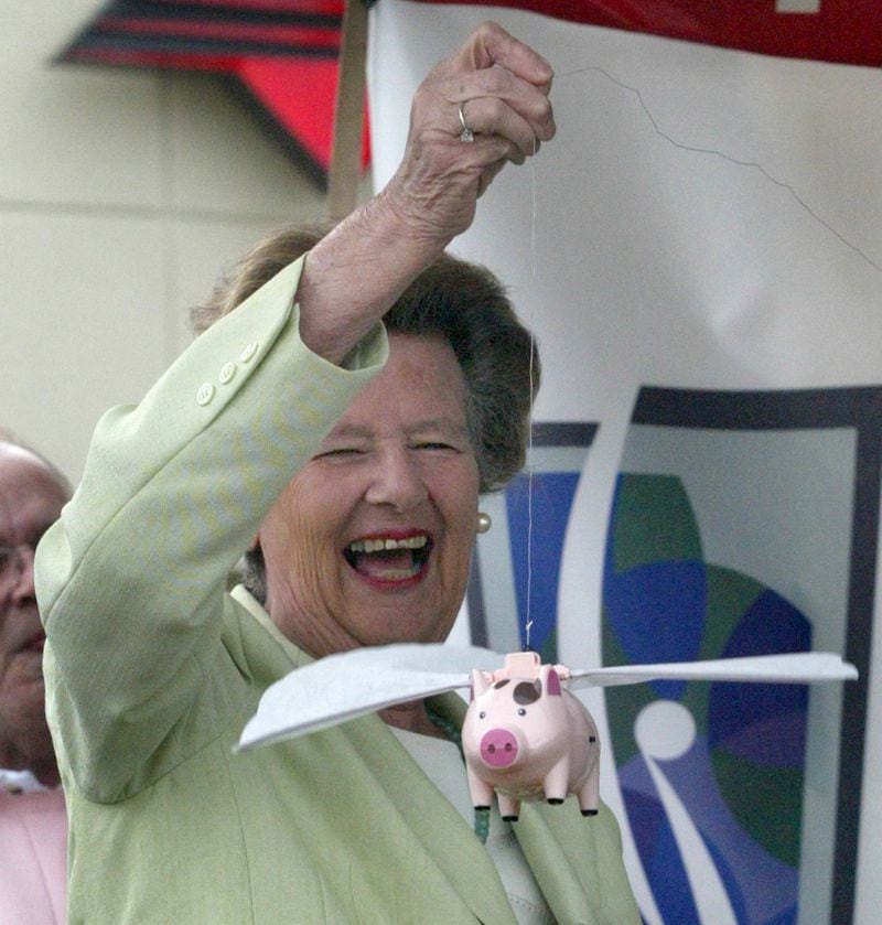 A 2005 file photo: Eva Galambos holds a flying pig because critics once said that Sandy Springs would be a city "when pigs fly."