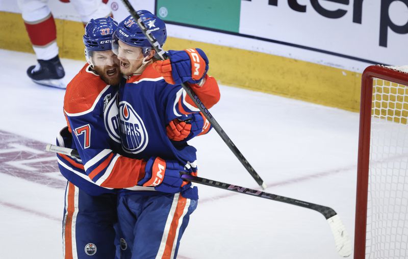 Edmonton Oilers' Ryan McLeod (71) celebrates his goal against the Florida Panthers with Warren Foegele (37) during the third period of Game 6 of the NHL hockey Stanley Cup Final, Friday, June 21, 2024, in Edmonton, Alberta. The Oilers won 5-1 to tie the series. (Jeff McIntosh/The Canadian Press via AP)