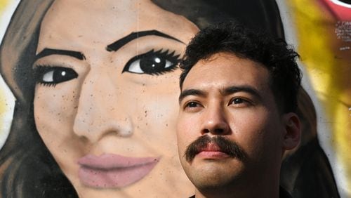 Ali Abdulrab stands in front of a mural honoring his sister Mariam on Wylie Street near the Krog Street tunnel. Mariam was abducted and killed in 2021, allegedly by a recently paroled sex offender. Her death inspired a new law imposing additional tracking of offenders when they leave prison.  (Hyosub Shin / Hyosub.Shin@ajc.com)