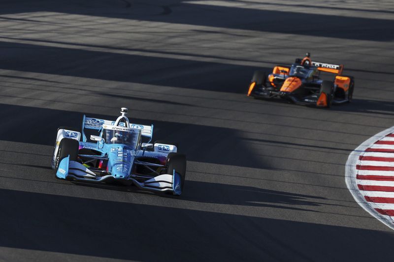 Josef Newgarden, left, drives during an IndyCar auto race on Saturday, Aug. 17, 2024, at World Wide Technology Raceway in Madison, Ill. (Zachary Linhares/St. Louis Post-Dispatch via AP)