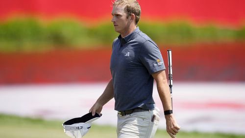 Jacob Bridgeman walks on the 18th green after making a birdie putt during the first round of the 3M Open golf tournament at the Tournament Players Club, Thursday, July 25, 2024, in Blaine, Minn. (AP Photo/Charlie Neibergall)