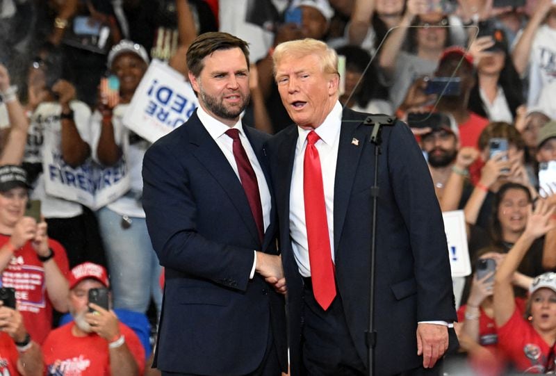 Former President Donald Trump and running mate JD Vance talk on the stage during a rally at the Georgia State University Convocation Center on Saturday, August 3, 2024 in Atlanta. (Hyosub Shin/AJC)