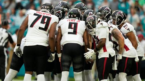 Atlanta Falcons quarterback Michael Penix Jr. (9) huddles with the offensive line during the first half of a pre season NFL football game Miami Dolphins, Friday, Aug. 9, 2024, in Miami Gardens, Fla. (AP Photo/Lynne Sladky)