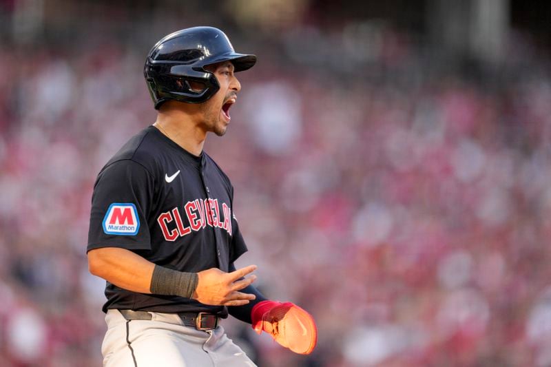 Cleveland Guardians' Steven Kwan scores on a bases-loaded walk issued by the Cincinnati Reds during the third inning of a baseball game in Cincinnati, Wednesday, June 12, 2024. (AP Photo/Jeff Dean)